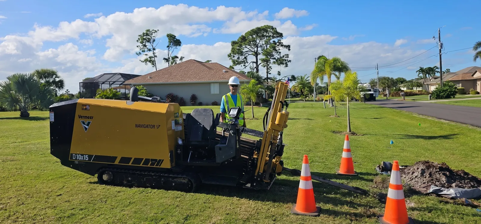 Horizontal directional drilling rig installing conduit under a residential road